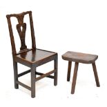 A 19th century carved oak side chair with plank seat and a rustic three legged stool (af) (2).