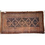 An Eastern style rug decorated with stylised motifs on red ground, approx 280 x 139cm (af).