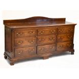 A George III oak mule chest with hinged lid and arrangement of dummy drawers over six real short