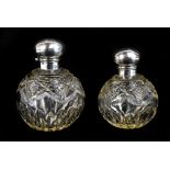 WILLIAM VALE & SONS; two George V cut glass perfume bottles with hallmarked silver covers, Chester
