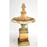 A 19th century cream painted cast iron urn with water fountain fixture, the cover with pine cone