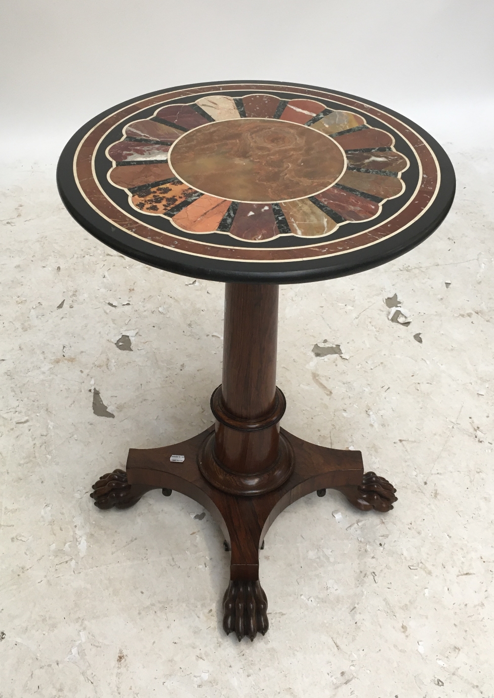 A 19th century circular specimen marble table top with sunburst style decoration, indistinct paper