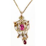 An Edwardian 9ct yellow gold pendant on fine link yellow metal chain and presented in an Elkington &