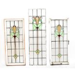 A pair of leaded stained glass windows, in wooden frames, approx 136 x 56cm, and another unframed (