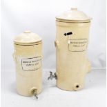BRITISH BERKEFELD FILTERS LTD; two ceramic filters with printed detail and taps, height of largest