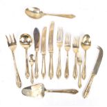 A quantity of brass cutlery and flatware in Lotus pattern, comprising eight dinner knives and forks,
