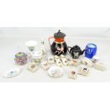 A small group of crested Goss ware, a Poole Pottery sugar bowl, a teapot with Etruscan decoration,