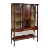 An Edwardian inlaid mahogany twin door display cabinet with two glazed doors flanked by central