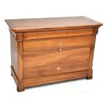 A walnut chest of four drawers with rounded front corners on carved feet, approx 88.5 x 128cm.