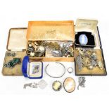 A group of costume jewellery to include a charm bracelet, a filigree white metal bracelet, etc.