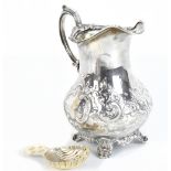 HENRY HOLLAND; a Victorian hallmarked silver repoussé decorated jug, London 1868, height 13.5cm,