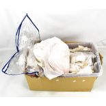 A quantity of linen to include napkins, beaded purses, doilies, etc.