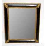 A reproduction gilt and black framed wall mirror, width 78cm.