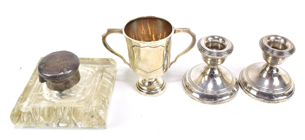 A George V hallmarked silver twin handled trophy cup with vacant shield shaped cartouche, Birmingham