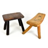 A rustic elm milking stool raised on three outswept supports and retaining traces of original