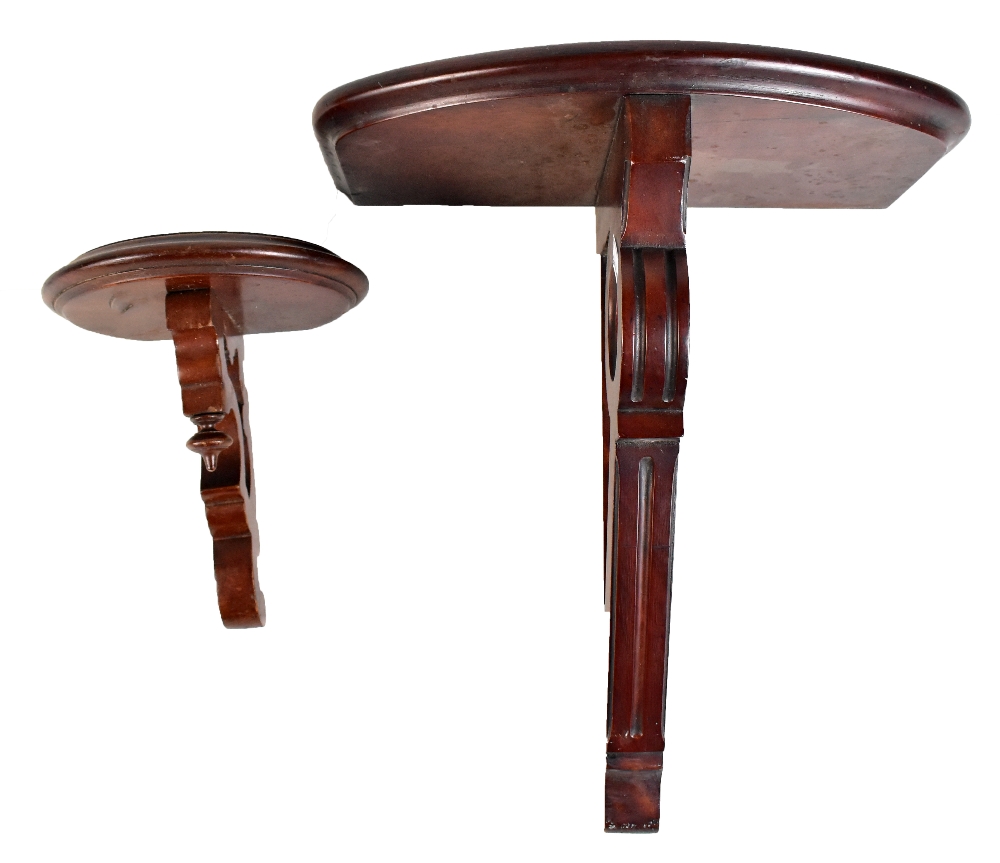 A mahogany wall bracket with demi lune platform and pierced scrolling support, length 35cm and a