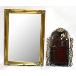 A reproduction gilt framed overmantel bevelled wall mirror, 76 x 106cm, and a smaller shaped