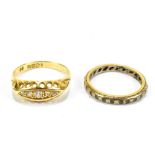 An 18ct yellow gold and diamond five stone dress ring, size, N 1/2, and an 18ct eternity ring set