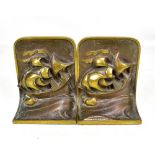 A pair of Arts and Crafts style book ends decorated with galleons, height 14cm.