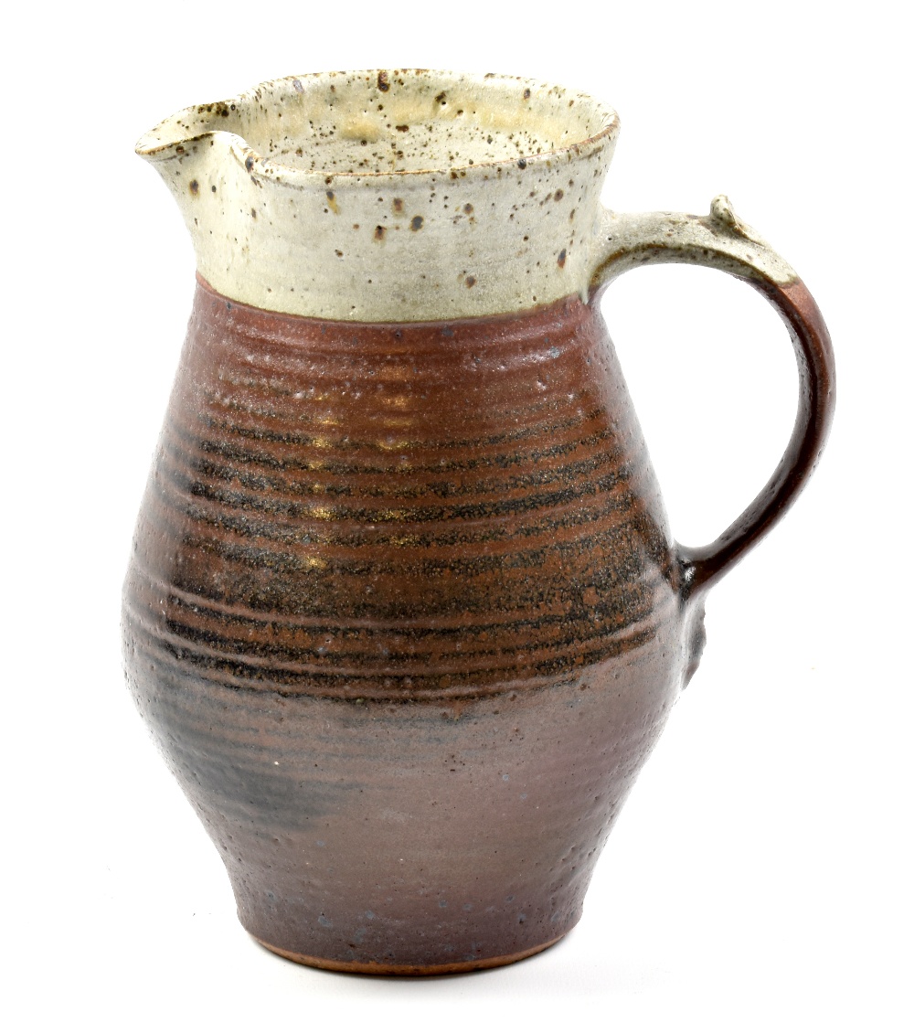 GEORGE COOK (1919-1982); an early stoneware jug covered in kaki glaze with iron spotted grey rim,