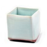 MARGARET CURTIS (born 1955); a square porcelain vase covered in celadon glaze with copper red