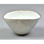 DAME LUCIE RIE (1902-1995); a squeezed stoneware bowl covered in white glaze with manganese rim,