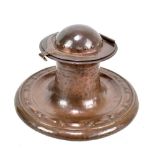 JESSON BIRKETT & CO; an Arts and Crafts copper inkwell with relief and planished decoration,
