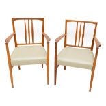 GORDON RUSSELL; a set of six oak framed spindled back elbow armchairs on tapering block supports (