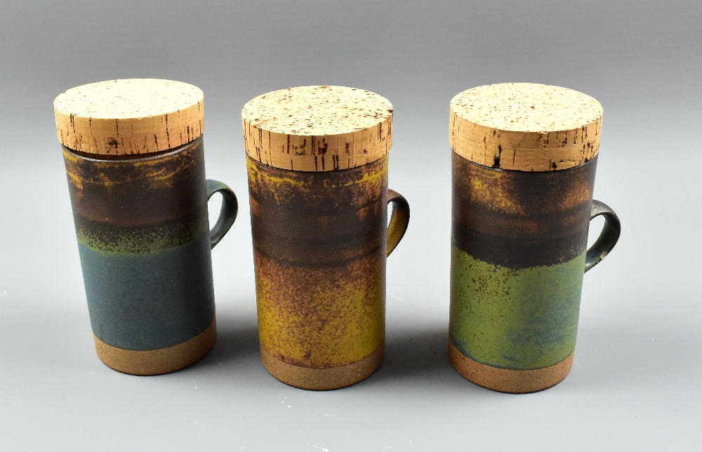 ROBIN WELCH (1936-2019); three tall stoneware mugs with original cork covers, impressed marks,