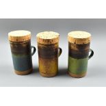 ROBIN WELCH (1936-2019); three tall stoneware mugs with original cork covers, impressed marks,