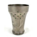 OSIRIS; an Arts and Crafts pewter beaker relief decorated with floral designs with green glass