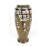 BESSIE NEWBERRY FOR ROYAL DOULTON; a footed cylindrical vase, decorated with stylised blossom,