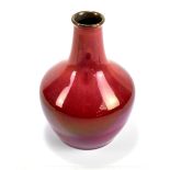 ROYAL LANCASTRIAN; a glazed bulbous vase with cylindrical neck, decorated with oxblood glaze with