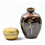 MIKE DODD (born 1943); a stoneware bottle covered in tenmoku breaking to kaki glaze, with wax resist