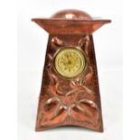 IN THE MANNER OF JOHN PEARSON; an Arts and Crafts copper mantle clock, with planished and relief