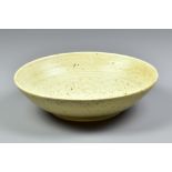 JOANNA CONSTANTINIDIS (1927-2000); a stoneware bowl covered in oatmeal glaze with iron spots,