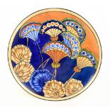 WOOD & SONS; an art pottery charger with floral decoration on a brown and blue ground, attributed to