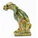 IAN GREGORY (born 1942); a stoneware sculpture of a seated dog covered in streaky green and yellow