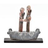 JOHN MALTBY (born 1936); a stoneware sculpture of a family group on a boat, mounted on wooden