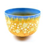 PETER LANE (born 1932); a deep porcelain footed bowl brightly decorated in shades of yellow and
