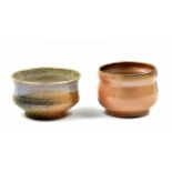 HWANG JENG-DAW (born 1963); two wood fired stoneware footed tea bowls with ash glaze decoration,