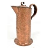 WILLIAM SOUTER; an Arts and Crafts copper cylindrical jug with planished decoration and central
