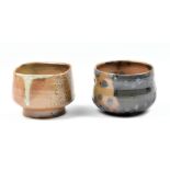 HWANG JENG-DAW (born 1963); two wood fired stoneware footed tea bowls with ash glaze decoration,