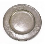 ENGLISH PEWTER; an Arts and Crafts pewter plate relief decorated with stylised trees on a