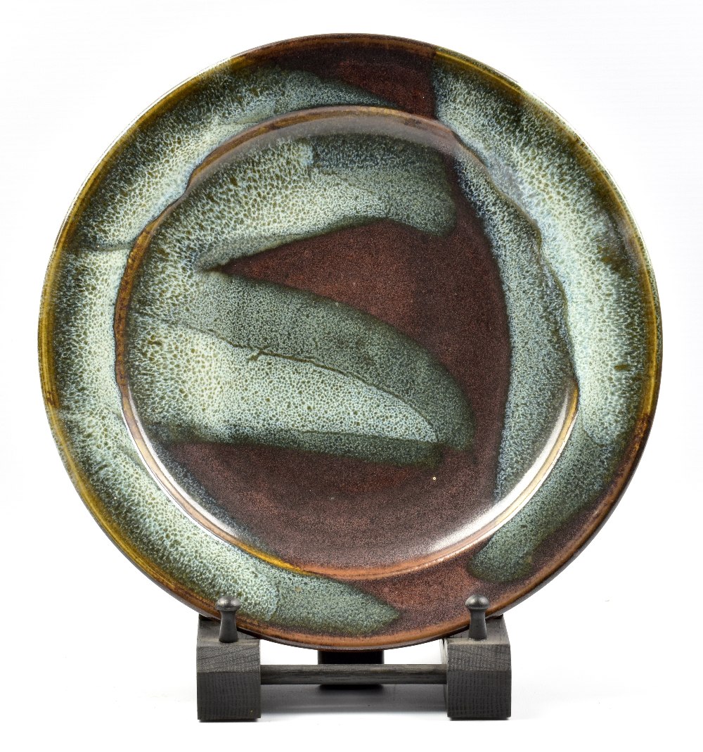 RAY FINCH (1914-2012) for Winchcombe Pottery; a stoneware platter, ash pours on iron rich ground,