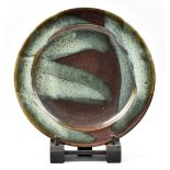 RAY FINCH (1914-2012) for Winchcombe Pottery; a stoneware platter, ash pours on iron rich ground,
