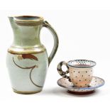 MORGEN HALL (1960-2016); a tin glazed earthenware cup and saucer, impressed marks, height 9cm, and a