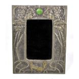 An Arts and Crafts sheet pewter easel back mirror, relief decorated with grapes and vine leaves