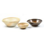 MASANOBU IZUMIHARA; three anagama fired stoneware pouring bowls, impressed marks, largest diameter