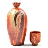 LISA HAMMOND (born 1956); a stoneware bottle covered in shino glaze with combed decoration,